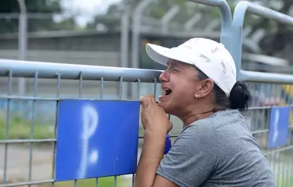 A woman cries outside the Guayas 1 prison after clashes between inmates in Guayaquil, Ecuador on July 23, 2023. Drug-linked violence in Ecuador last year propelled the homicide rate to 26 per 100,000 inhabitants, nearly double the previous year's level. [Gerardo Menoscal / AFP]