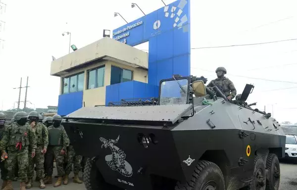 Members of the Ecuadorean Armed Forces stand guard outside the Zonal Penitentiary No 8 in Guayaquil, Ecuador, during a joint operation between the Police and the Military on August 12, 2023. A 4.000-stong joint force carried out a security operation in the prison in the framework of the state of emergency declared in the country on August 10, following the assassination of popular presidential candidate Fernando Villavicencio. [Gerardo Menoscal / AFP]