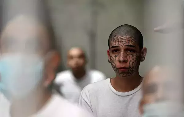 Inmates remain inside a cell at the Counter-Terrorism Confinement Centre (CECOT) mega-prison, where hundreds of members of the MS-13 and Barrio 18 gangs are being held, during a humanitarian visit organized by the presidential commissioner for human rights and freedom of expression, Andrés Guzman Caballero of Colombia, in Tecoluca, 74km southeast of San Salvador, on August 21. [Marvin Recinos/AFP]