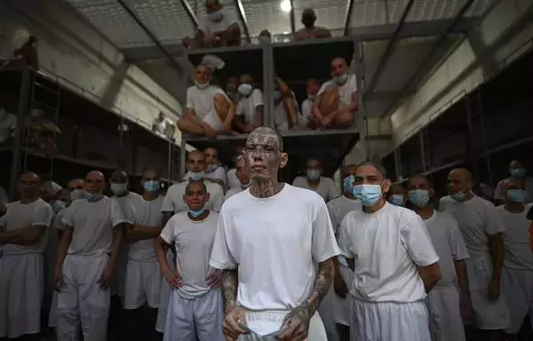 Inmates remain in a cell at the Counter-Terrorism Confinement Centre (CECOT) mega-prison, where hundreds of members of the MS-13 and Barrio 18 gangs are being held, during a humanitarian visit organized by the presidential commissioner for human rights and freedom of expression, Andrés Guzman Caballero of Colombia, in Tecoluca, 74km southeast of San Salvador, on August 21. [Marvin Recinos/AFP]