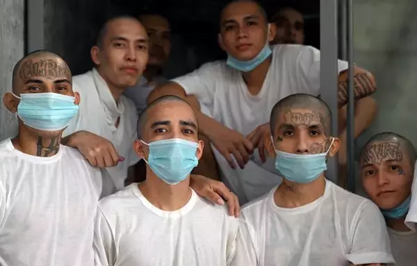 Inmates remain in a cell at the Counter-Terrorism Confinement Centre (CECOT) mega-prison, where hundreds of members of the MS-13 and Barrio 18 gangs are being held, during a humanitarian visit organized by the presidential commissioner for human rights and freedom of expression, Andrés Guzman Caballero of Colombia, in Tecoluca, 74km southeast of San Salvador, on August 21. [Marvin Recinos/AFP]