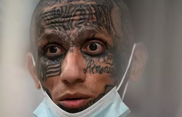 Inmates remain in a cell at the Counter-Terrorism Confinement Centre (CECOT) mega-prison, where hundreds of members of the MS-13 and Barrio 18 gangs are being held, during a humanitarian visit organized by the presidential commissioner for human rights and freedom of expression, Andrés Guzman Caballero of Colombia, in Tecoluca, 74km southeast of San Salvador, on August 21. [Marvin Recinos/AFP]