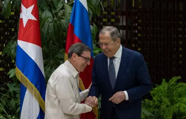 El ministro de Asuntos Exteriores ruso, Sergey Lavrov (derecha), y el ministro de Asuntos Exteriores de Cuba, Bruno Rodríguez, se dan la mano durante una reunión en La Habana el 20 de abril. [Ramón Espinosa/ARCHIVO/AFP]