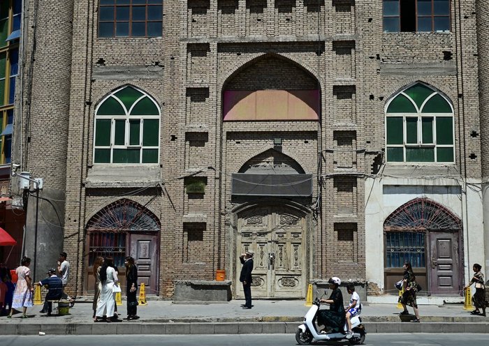 Personas frente a una mezquita en desuso en Kasgar, región de Sinkiang, China, el 13 de julio. [Pedro Pardo/AFP]