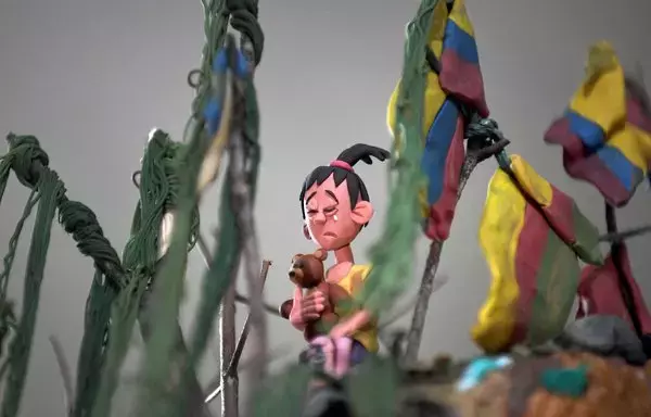 
Un detalle de la obra del artista colombiano Edgar Álvarez llamada "Loma de las Banderas" se muestra durante una entrevista en su estudio en Bogotá. Álvarez refleja en plastilina el sufrimiento de los migrantes en América. (Foto de Daniel Muñoz / AFP)        