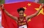 
Gold medalist He Jie of China celebrates following the conclusion of the men's marathon final during the 2022 Asian Games in Hangzhou, Zhejiang province, China. [William West/AFP]        