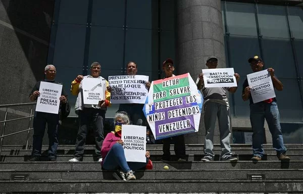 Familiares de personas detenidas durante las protestas relacionadas con las controvertidas elecciones presidenciales del 28 de julio y de otros presos se manifiestan exigiendo su liberación frente a la oficina del Programa de las Naciones Unidas para el Desarrollo (PNUD) en Caracas el 21 de octubre. [Federico Parra/AFP]