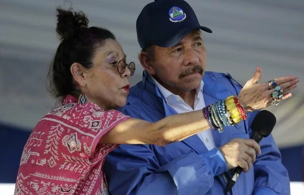 Nicaraguan Vice-President Rosario Murillo (left) gestures alongside her husband, President Daniel Ortega, during a rally in Managua in August 2018. [Inti Ocon/AFP]