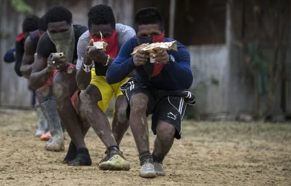 Miembros del Frente de Guerra Occidental Omar Gómez del grupo guerrillero ELN realizan ejercicios tácticos en su campamento a lo largo del río San Juan en Chocó, Colombia. [Luis Robayo/AFP]