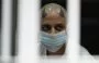 
An inmate looks out from his cell at the Counterterrorism Confinement Center (CECOT) mega-prison in Tecoluca, El Salvador. Home to hundreds of MS-13 and 18th Street gang members, CECOT is the largest prison in Latin America and a key symbol of the war on gangs. [Marvin Recinoa/AFP]        