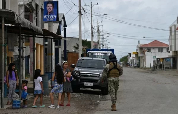 
An Ecuadorian soldier patrols Pitahaya in the Jambelí Archipelago, El Oro province. The once-bustling Puerto Bolívar port now stands nearly deserted, as local fishermen, vulnerable to escalating drug-related violence, fear speaking out. [Marvin Recinos/AFP]        