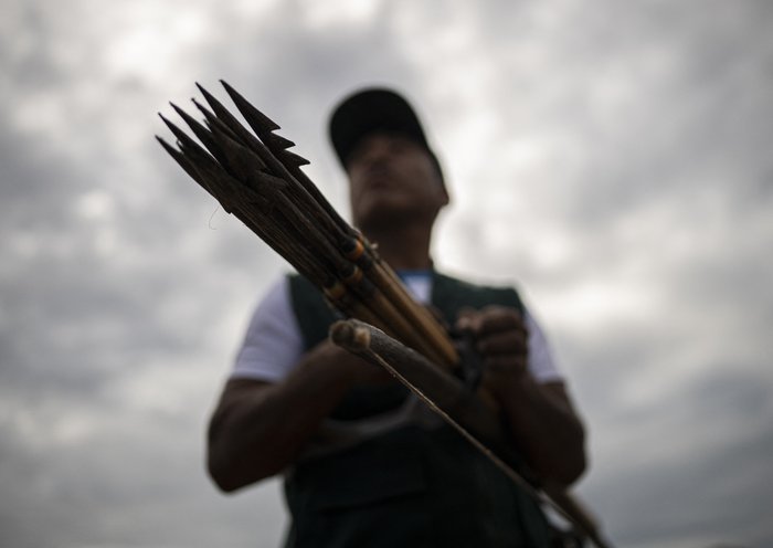 A member of the Shipibo Konibo Indigenous Guard prepares before going out on patrol against illegal loggers in Caimito, Ucayali department, Peru. [Ernesto Benavides/AFP]
